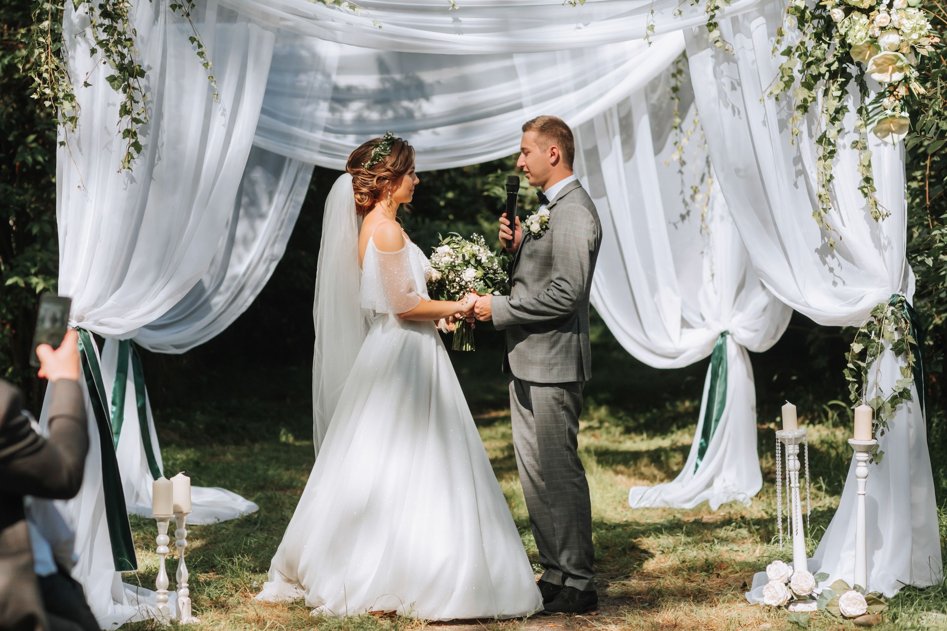 Beautiful wedding couple at a summer wedding ceremony. Wedding vows, emotions and tears
